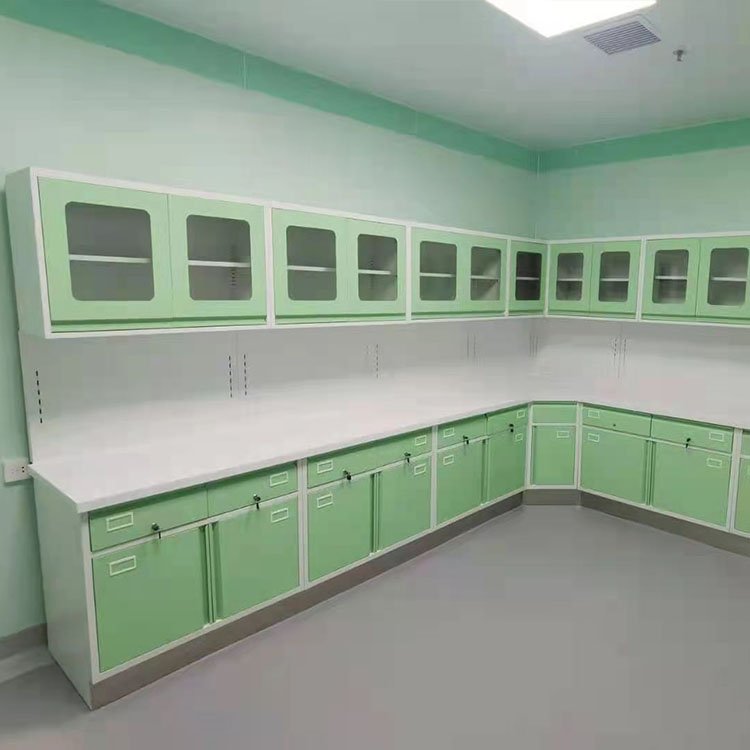 Green medical treatment cabinet with glass doors and white countertop in a healthcare setting